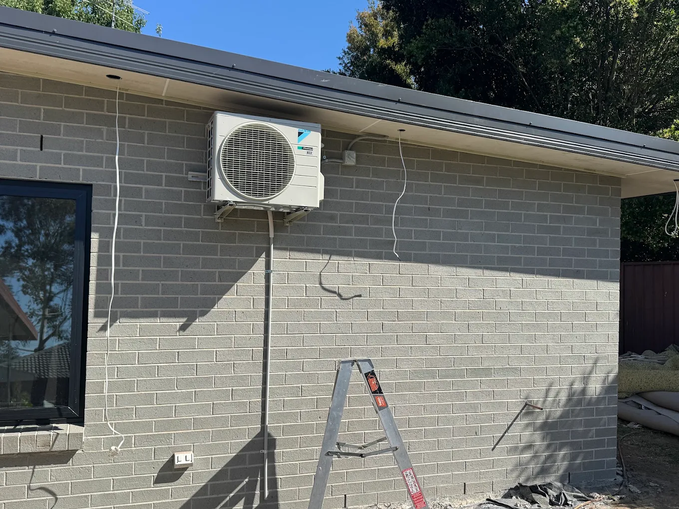 Daikin outdoor unit installed by JAE on a residential wall